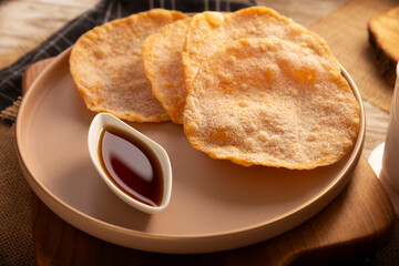 Mexican Buñuelos. Traditional food at Christmas and winter holidays in Mexico, these are fried flour tortillas sprinkled with sugar or covered in a syrup made with piloncillo, cinnamon, and guava.