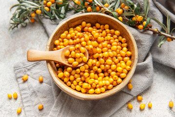 Sea buckthorn berries in wooden bowl