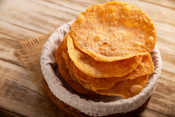 Mexican Buñuelos. Traditional food at Christmas and winter holidays in Mexico, these are fried flour tortillas sprinkled with sugar or covered in a syrup made with piloncillo, cinnamon, and guava.