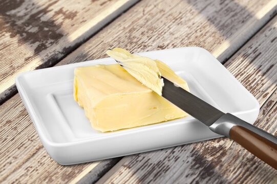 Sliced pieces of fresh butter on a table,