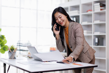 Office, business asian woman and laptop with phone call for communication, financial help or bank...