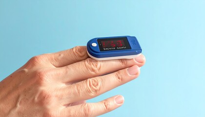 Close Up of a Digital Pulse Oximeter on a Person's Finger Against a Blue Background
