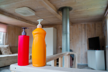 In a cozy wooden space, colorful bottles are arranged on rustic shelves, enhancing comfort and...