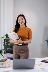 Business woman hands of paper files for searching and checking on laptop unfinished document archives on folders papers at busy work desk office