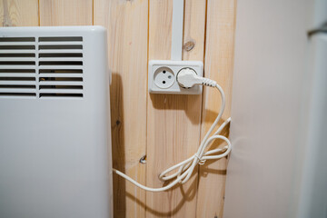 This wallmounted heater connects to a standard outlet, offering efficient warmth with easy...