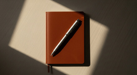 Capture thoughtful planning with a modern journal and pen, perfect for business strategy, creative writing, and personal reflection in soft natural light