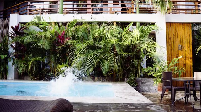 influencer girl standing by a pool and dives in, tropical summer getaway, Palomino pool scene