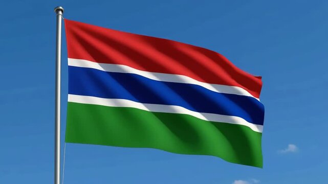 Gambia national flag waving against blue sky