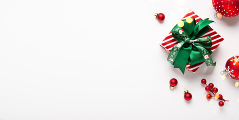 Merry Christmas and Happy Holidays greeting card, frame, banner. New Year. Red green Christmas decoration and gifts, presents on white background top view. Xmas holiday festive theme.