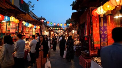 Evening market scene with colorful lanterns and diverse crowd