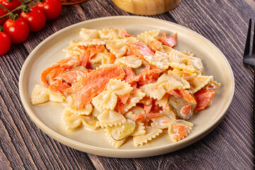 Italian pasta farfalle with salmon
