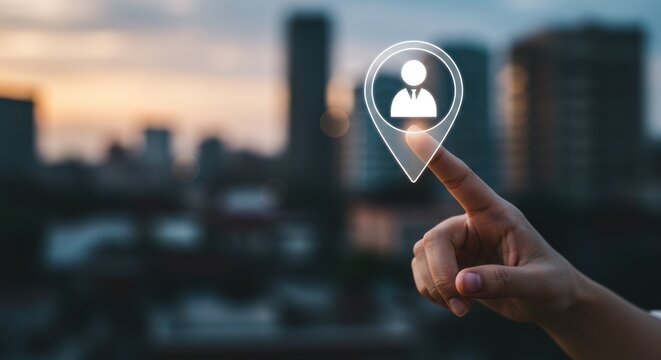 Hand touches location pin icon with person symbol over blurred cityscape background.