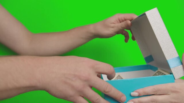 Green Screen Video: Woman Giving a Sealed Gift Box Containing 1 and 2 Bills to a Man, Who Counts the Money, Places It Back in the Box, and Takes the Gift