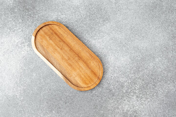 Elegant wooden tray placed on a textured gray surface for home decor