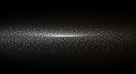 Abstract, blurred white dots illuminate a dark background, creating a soft, ethereal effect