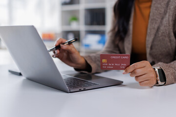 Business Payment banking, business woman hand on laptop making electronic payments with a credit card. Online shopping or tax payment concept
