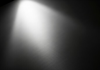 Spotlight on a dark background with textured surface