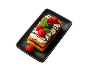 An elegant layered pastry adorned with whipped cream fresh raspberries a blueberry and chocolate drizzle served on a black plate