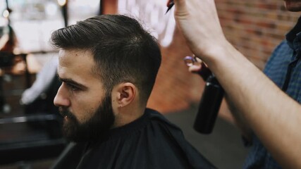 Professional barber precisely trimming a man's haircut with straight razor and shaping his hairline at a traditional barbershop, ensuring a clean and sharp look with grooming tools