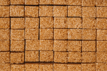 Fototapeta premium Brown sugar cubes arranged neatly on a flat surface for culinary use