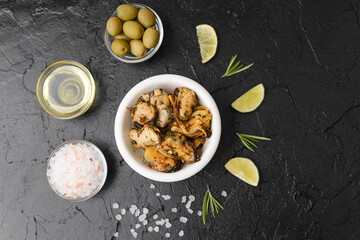 Seafood salad with rosemary and lime on black background for healthy lunch or Mediterranean snack concept
