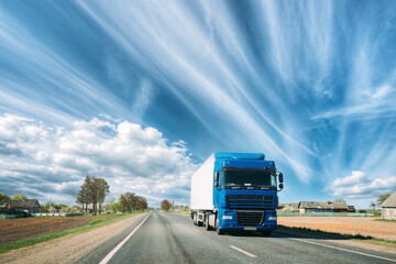 Truck On Country Road. Tractor Unit, Prime Mover, Traction Unit In Motion On Countryside Road In Europe. Business Transportation And Trucking Industry Concept