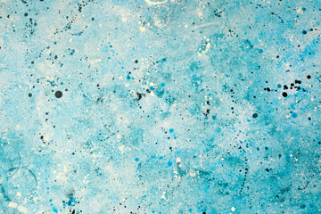 Abstract blue painting with splashes of color and texture on canvas surface