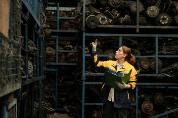 Portrait woman Middle east technician or engineer use walkie talkie checking auto part or car part at car part warehouse	