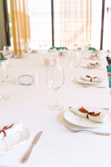 Elegant dining setup in a bright restaurant at sunset