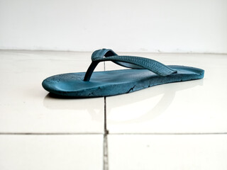 Blue flip flops made of rubber, look worn after long use