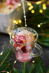 Festive Dessert With Marshmallows, Whipped Cream, and Milk Being Poured in a Cozy Holiday Setting With Twinkling Lights
