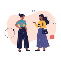 Two women having a conversation while standing together.