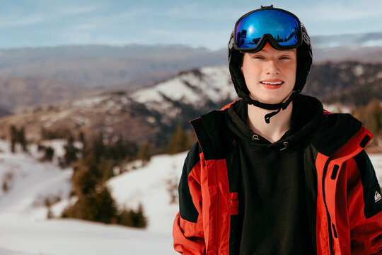 Young man smiling wearing ski wear on mountain