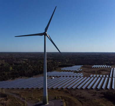 Wind turbine generator and solar panels for clean energy production.