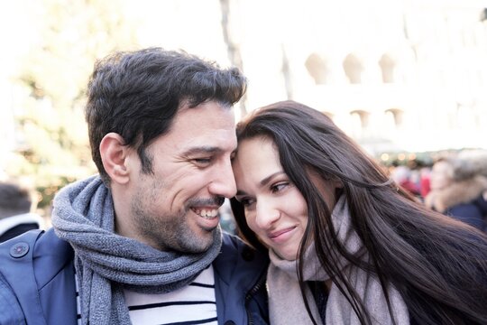 man and woman being inclined towards each other in winter clothes