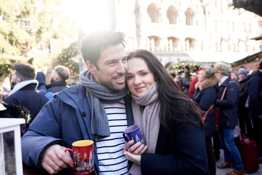 satisfied couple at christmas market, hot spiced fruit or wine punch