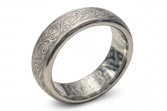 Silver wedding band with ornate filigree engraving, a symbolic piece of jewelry for marriage and commitment