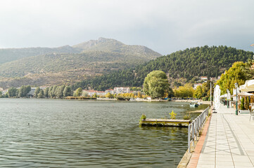 Lake and mountain landscape near Kastoria, Greece, under light clouds on an autumn day.