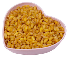 Isolated Bulgur in a heart-shaped saucer on a white background. Top view