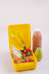 Yellow Lunch Box with Sandwich and Fruit