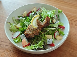 Grilled meat dishes, including lamb chops and beef steak, served with a fresh green salad for a delicious gourmet dinner