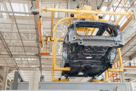 Automotive industry assembling conveyor line, car body suspended with bracket.