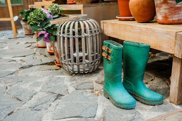 Artistic floral arrangement with hydrangeas and rubber boots for gardening and floral styling