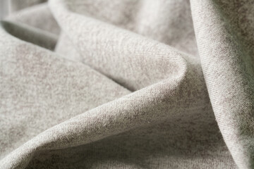 Soft heathered grey brown knit with gentle folds, cozy melange texture for a winter background, macro close up. Photo