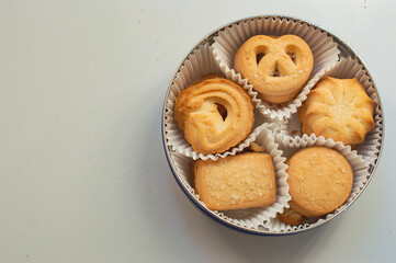 Box of cookies with shaped biscuits on white background with copy space
