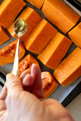 Drizzling honey over butternut squash before roasting