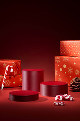 Minimal red gift boxes and ribbons on dark background. Elegant composition for Christmas product mockups or festive templates.