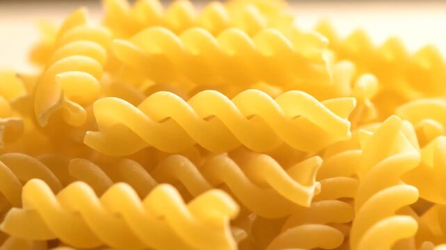 Close up of dry fusilli pasta spirals in a pile.