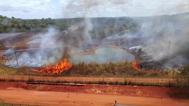 Aerial clip of a wild grass fire and smoke at the edge of a remote community in Cape York, Australia. Clip 5