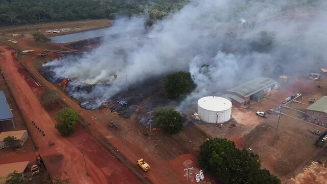 Aerial clip of a wild grass fire and smoke at the edge of a remote community in Cape York, Australia. Clip 1